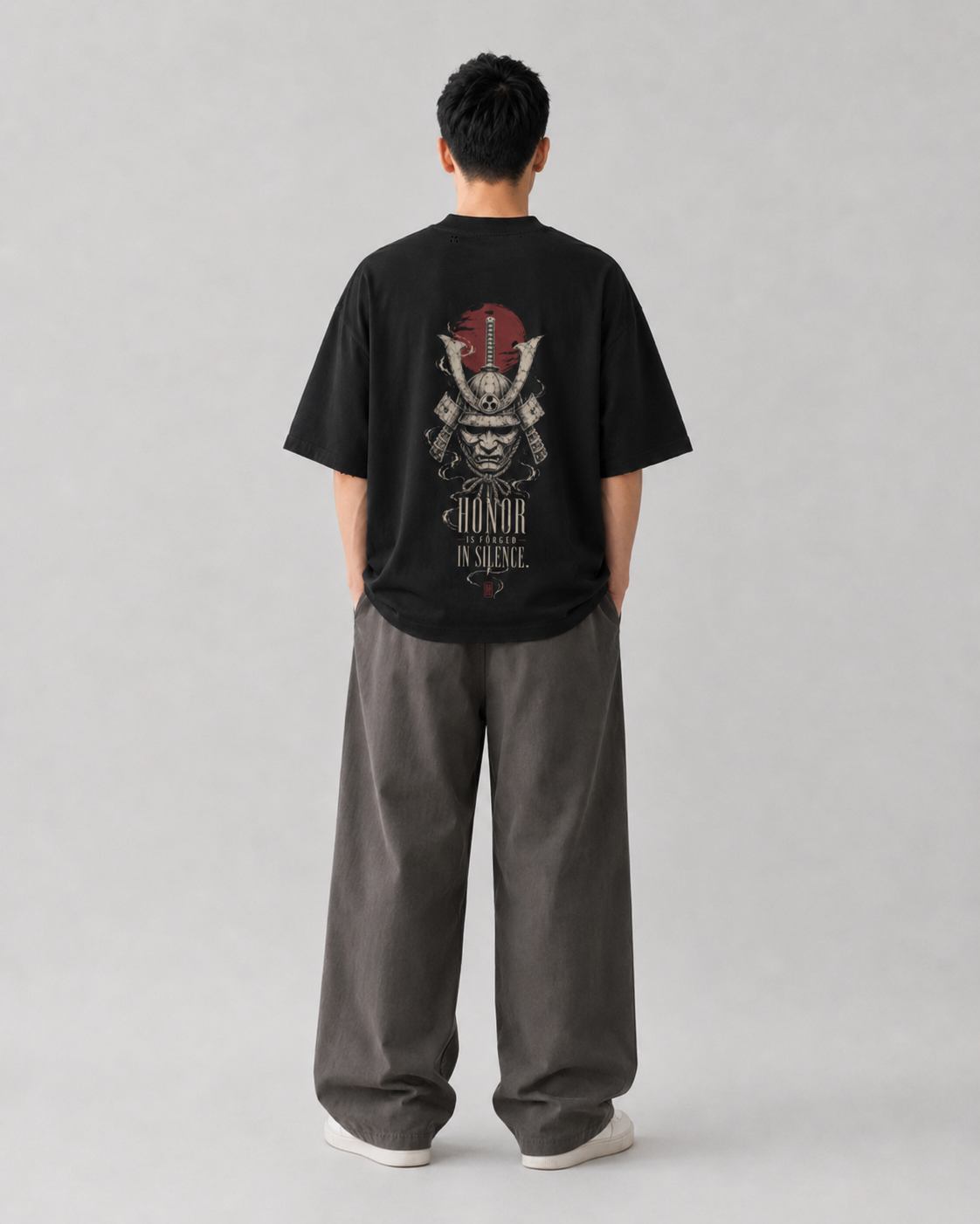 Model wearing the KUROGANE Forged in Silence oversized Japanese samurai streetwear tee